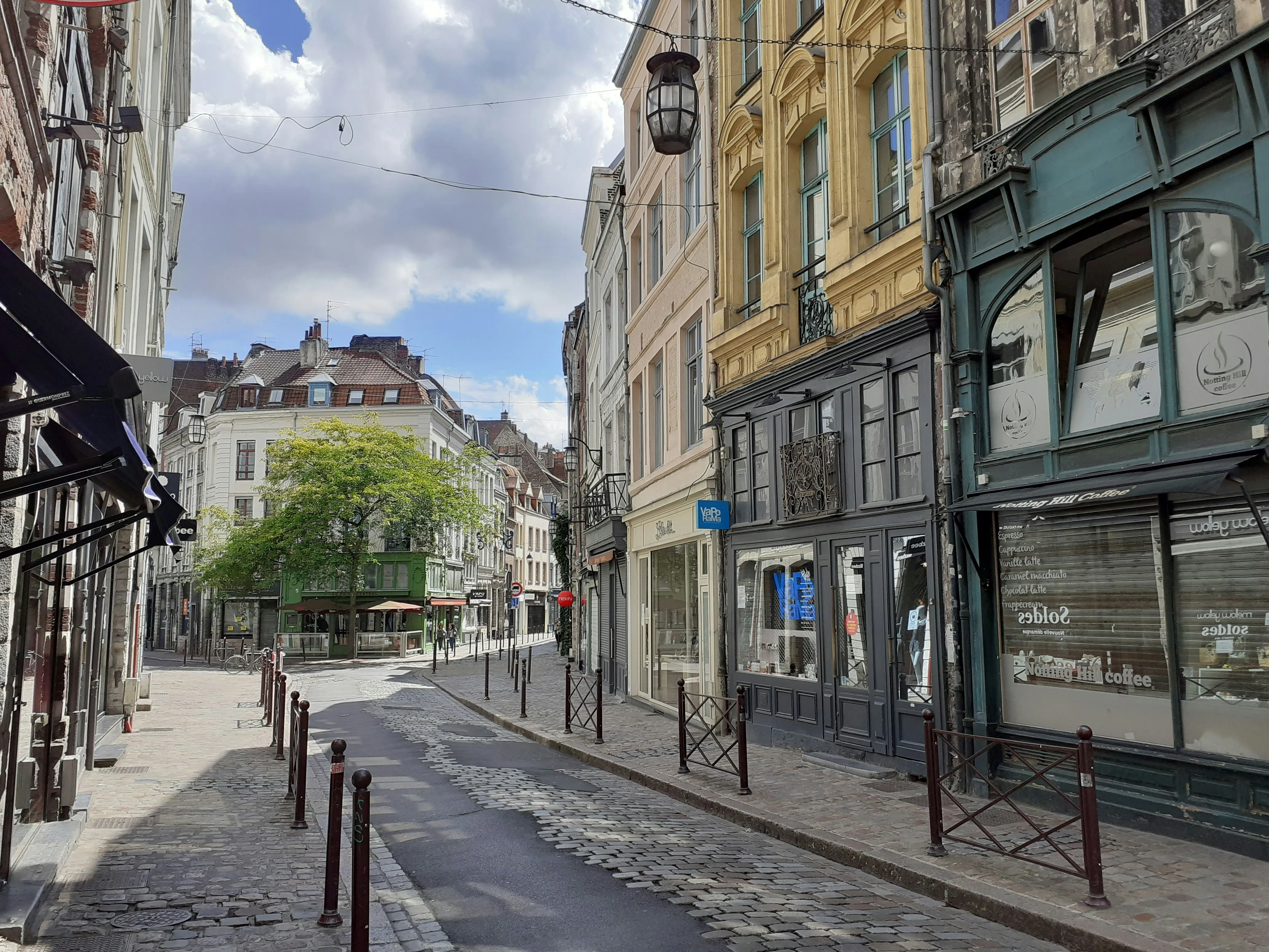 A curving shopping street of old brick and stone houses in Vieux Lille